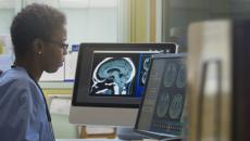 A radiologist looking at brain imaging results in a hospital.