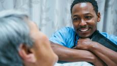 Healthcare provider speaking to a patient while smiling